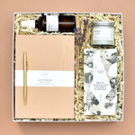 Load image into Gallery viewer, scandinavian luxury british gift box featuring small independent businesses. includes A5 notebook, gold pen, The Chocolatier almonds, hoco and co roam soy wax candle, and hobo and co room mist in rest. gift for her, employee gift
