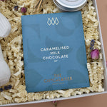 Load image into Gallery viewer, new mum and baby pamper luxury gift box. With organic baby bunny rattle, handmade rose geranium and cedar bar of soap, orchard blossom scented handmade tin candle, bar of caramelised milk chocolate, decorative keepsake floral arrangement.
